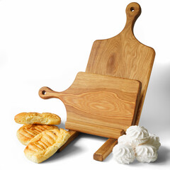 Fresh white marshmallows, bread and two homemade solid oak wooden cutting boards with round handles and stand on a white background. Photo. Daylight