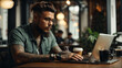 © Loki Studio - Young man working on laptop in cafe having coffee on table. man with tattoo, designer freelancer or student work on computer laptop at table.