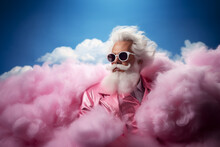 Fashion Santa Claus In Pink Suit And Sunglasses Among The Clouds. Creative Christmas Scene
