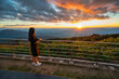 © Noppasinw - Tropical forest nature landscape view with woman tourist looking sunset mountain range at Doi Inthanon, Chiang Mai Thailand