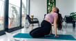 © DusanJelicic - Happy pregnant woman doing stretches and breathing exercise on a yoga mat
