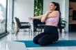 © DusanJelicic - Beautiful pregnant woman practicing yoga at home as she watches guided yoga on her laptop