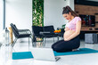 © DusanJelicic - Healthy pregnant woman sitting on a yoga mat and feeling her baby kicking