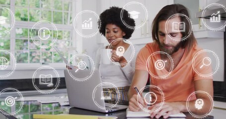 Poster - Animation of icons over diverse couple drinking coffee and writing in diary while using laptop