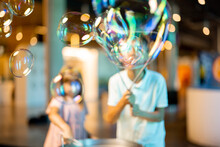 Little Girl And Boy Make Soap Bubbles, While Playing Together And Having Fun In A Science Museum. Concept Of Children's Entertainment And Learning
