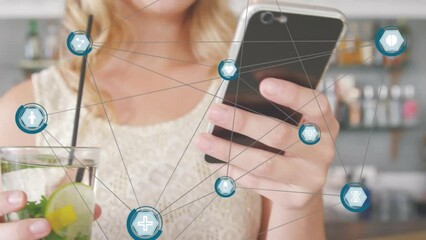 Poster - Animation of network of digital icons against mid section of a woman using smartphone at a bar
