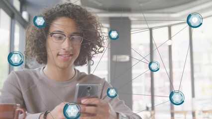 Poster - Animation of network of digital icons against biracial man smiling while using smartphone at a cafe