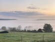Beautiful countryside sunrise landscape with mist in the valley