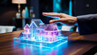 © Keitma - Man hand near a concept hologram render model of a real estate house on a table in an agency , futuristic business concept