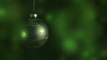 Wall Mural - focus on hanging glittering green christmas tree ball decoration on abstract bokeh background animation with copy space for text or product presentation, xmas holiday concept