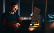 © Jacob Lund - Virtual meeting at night: Businessman connecting with his colleagues while working from home