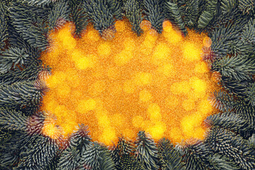 Wall Mural - golden glitter texture framed by christmas tree branches and bokeh lights