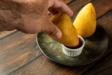 Wall Mural - two traditional Brazilian coxinhas. typical fried snack food stuffed with meat and chicken