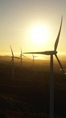 Wall Mural - Aerial drone of Wind Farm with wind turbines on the seashore at sunset. Wind power plant. Philippines.