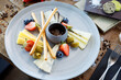 Cheese platter for two: Goat cheese cream, gorgonzola, camembert, grissini and fig jam. Delicious healthy Italian traditional food closeup served for lunch in modern gourmet cuisine restaurant