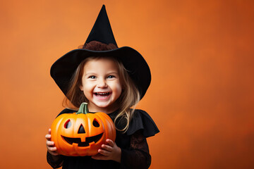 Wall Mural - Little witch with a pumpkin on color background