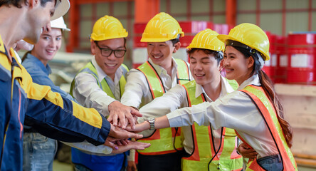 Group of young Engineer United stack hands or join hand teamwork together with Spirit diversity solidarity team Partner in metal sheet factory. Joins hands together teamwork meetings empower.