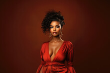 Young Beauty Stylish African American Woman In A Red Dress With A Deep Neckline On Vinous Background, Portrait Of Black Fashion Sexy Model With Beautiful Makeup And Hairstyle