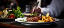 Unfamiliar Individual Serving Steak Meal With Fries And Salad Restaurant Cuisine Indoor Image