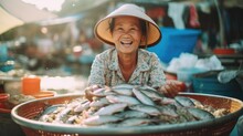 Happy Senior Southeast Asian Woman Sells Fish At Street Market