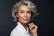 © SOLDATOOFF - Portrait of a mysterious fifty year old woman with a well-groomed face against a dark background.