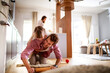 © Geber86 - Young Caucasian father playing with his daughter at home in the living room