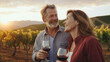 © Concept Island - Wine tasting in the vineyard. Middle-aged couple, about 50 years old, enjoying a glass of red wine at sunset in a vineyard.