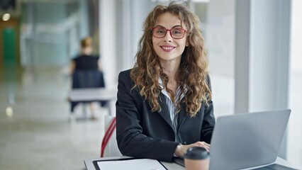 Wall Mural - Young woman business worker using laptop smiling at the office