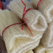 Strands Of A White Fibre Tied With Red String In Bundles