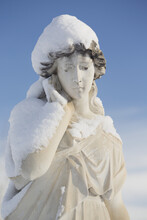 Statue Of A Woman Covered In Snow In Burnsland Cemetery; Calgary, Alberta, Canada