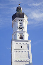 Clock Tower Against A Blue Sky Topped With A Cross; Landsberg, Bayern, Germany