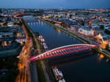 Fototapeta Miasto - Krakow, Poland, aerial view of the Kazimierz and Podgorze districts with Vistula river bridges in the night