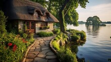 The Charm Of A Lakeside Cottage With A Thatched Roof And A Cobblestone Pathway