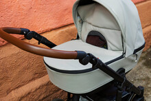 An Empty Baby Stroller Near A Brick Wall. An Increase In The Birth Rate. Social Problem