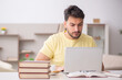 © Elnur - Young male student studying at home