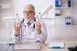 © Elnur - Old male doctor working in the clinic