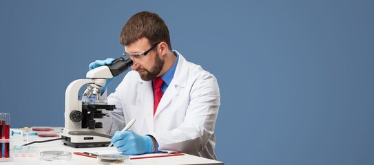 Poster - Scientist examining a sample with microscope, research concept