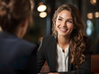 A smiling female manager conducts a relaxed interview with a candidate. Woman manager with a bright face and smile in a friendly and professional environment.