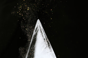 Canvas Print - triangle shape ice block on black background