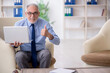 © Elnur - Old male employee sitting on arm-chair