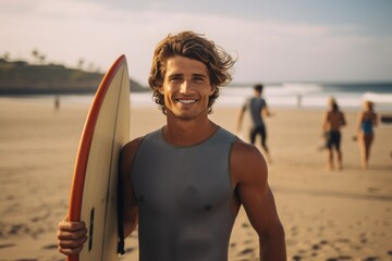 Wall Mural - Smiling portrait of a happy male caucasian surfer in California on a beach