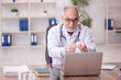 © Elnur - Old male doctor in telemedicine concept