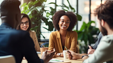 Diverse employees gathered brainstorming together in co working office, staff listen team leader, African woman share ideas, offer solutions concept.