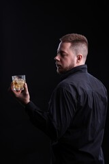 Canvas Print - Strict and stylish man with glasses whiskey. Drinking concept.