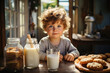 Children breakfast, cute caucasian shaggy little boy at table with cookies and milk in kitchen in morning