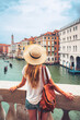 Woman tourist admiring Venice canal and building- tour tourism, vacation or travel destination concept