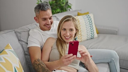 Poster - Man and woman couple using smartphone high five at home