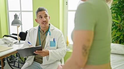 Poster - Man and woman doctor and patient having consultation writing medical report at the clinic