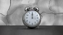 Fast Moving Hands And Alarm Bells Ringing On Silver Alarm Clock On Distorting Grey Background