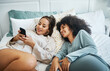© aLListar/peopleimages.com - Phone, social media and a lesbian couple in bed together in the morning for communication or to relax. Love, lgbt and a woman watching a movie or video with her girlfriend in the home bedroom